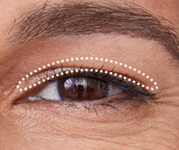 Extreme close up of a hooded eye with dotted outline for crease eye shadow placement.