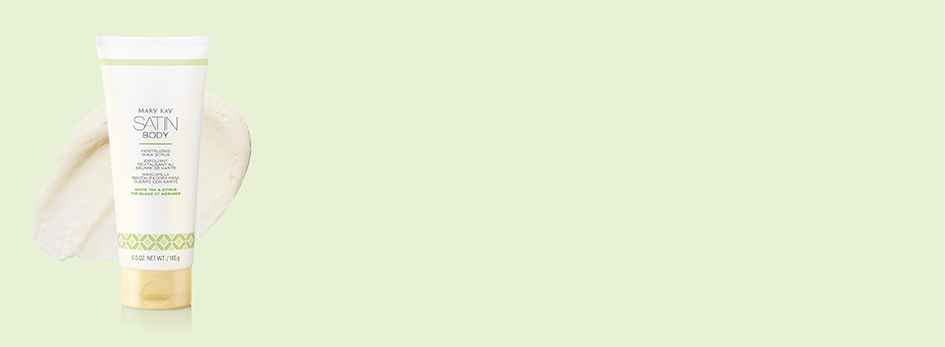 De Satin Body® Revitalizing Shea Scrub White Tea & Citrus ligt samen met een witte, gladde productklodder op een limoengroene achtergrond.