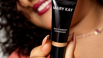 Een vrouw houdt een tube Multi-Benefit Concealer van Mary Kay voor de camera.