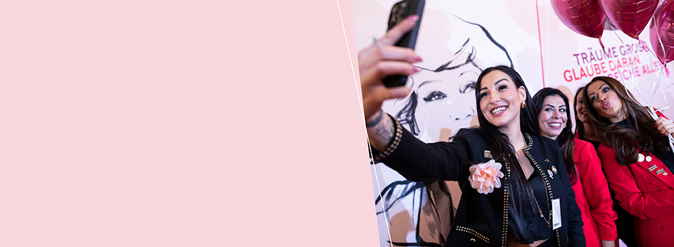 Drie vrouwen met een stralende huid houden elkaar in hun armen.