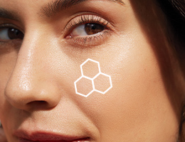 Close-up van een brunette vrouw die een gezichtshelft laat zien, met een wenkbrauw, een bruin oog en haar neus met een contour van het TimeWise® 3D complex op haar wang